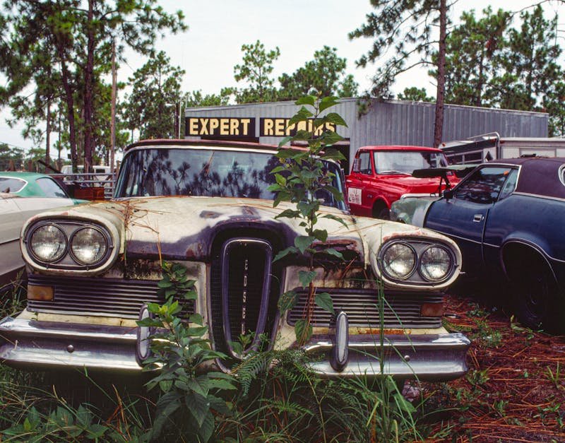 Explore decaying vintage cars in Bithlo, Florida, showcasing nature's reclaiming touch.