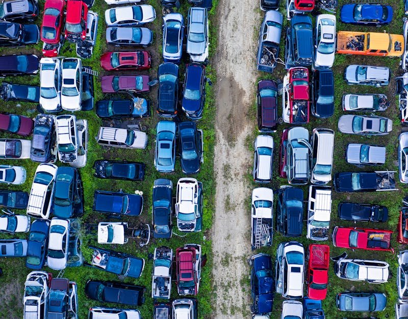 Aerial view of a car junkyard in Red Wing, MN, showcasing rows of parked vehicles.